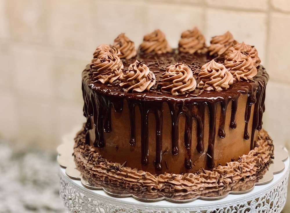 Chocolate drip cake with piped chocolate rosettes
